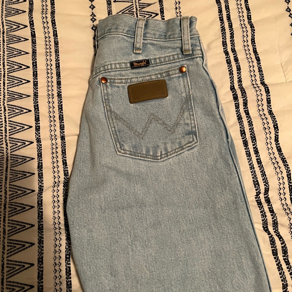 Light wash men’s cowboy cut Wrangler jeans